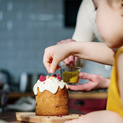 Mother and daughter decorating a cake